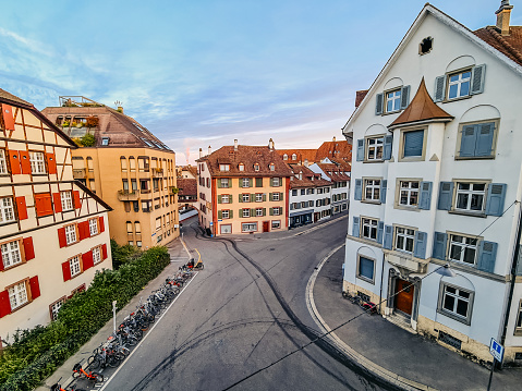 Street with half-timbered traditional houses and bicycles parked on the outdoor bike rack in Basel, Switzerland.