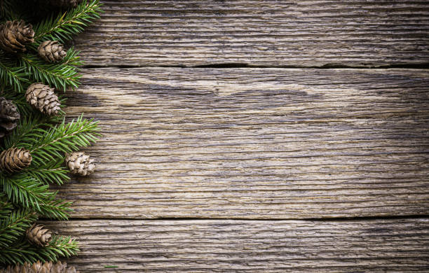 istock Christmas tree branches and pine cones on old cracked board 1845058341