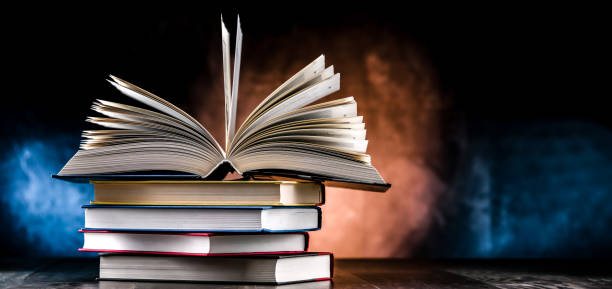 istock A composition with an open book lying on a stack of other books 1845074761