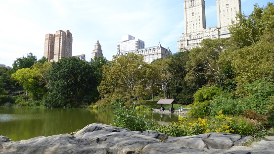 Central Park in New York on a September Tuesday, 2017. Autumn aura in the central part of the city. A place of rest and recreation for New Yorkers. View from the park of the surrounding buildings.
