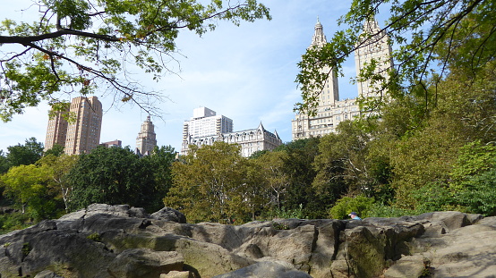 Central Park in New York on a September Tuesday, 2017. Autumn aura in the central part of the city. A place of rest and recreation for New Yorkers. View from the park of the surrounding buildings.