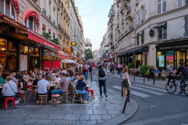 Parisian Lifestyle Paris, France - October 8, 2023 : Tourists and Parisians enjoying food and drinks outdoors at a the popular Rue de Buci in Saint Germain Paris France french restaurant pictures stock pictures, royalty-free photos & images