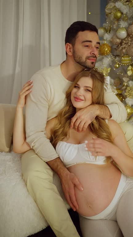 A pregnant couple celebrates the new year