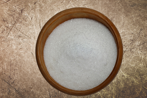 White sugar in a wooden bowl