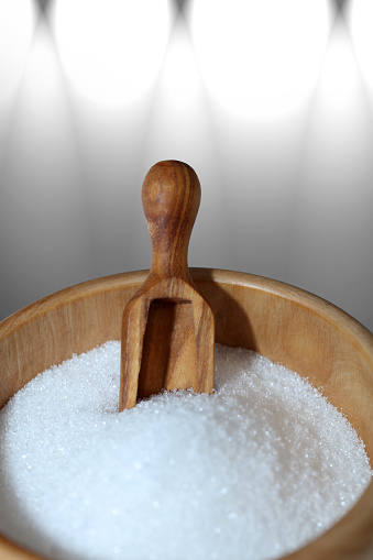 White sugar in a wooden bowl