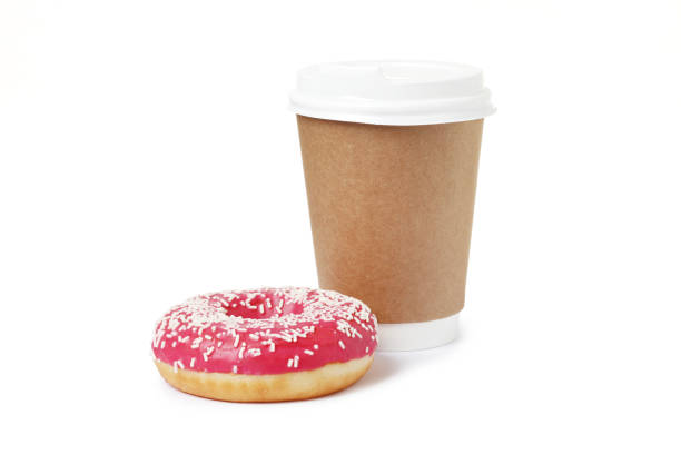 istock Cup of coffee with tasty donut on white background 1845253157