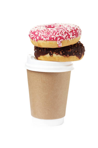 istock Cup of coffee with tasty donuts on white background 1845255261