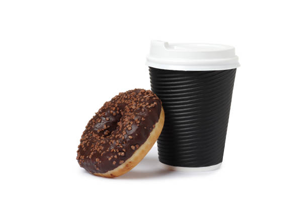 istock Cup of coffee with tasty donut on white background 1845255264