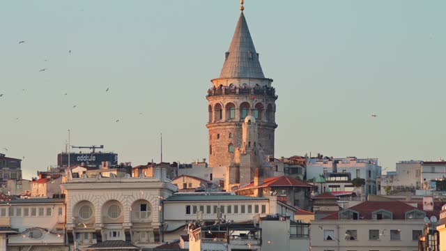 Scenic view of the Galata Tower and the rooftops of Istanbul from the Bosphorus at sunset