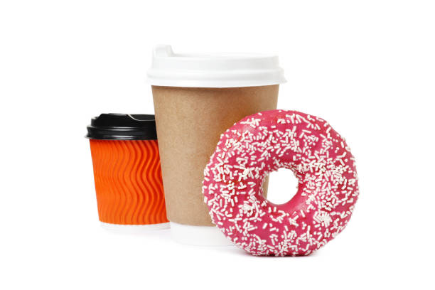 istock Cup of coffee with tasty donut on white background 1845259974