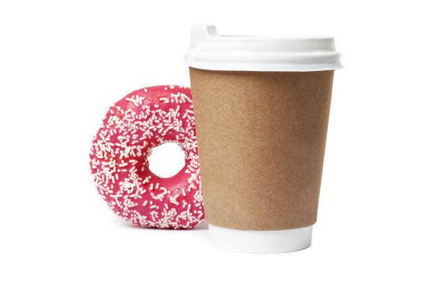 istock Cup of coffee with tasty donut on white background 1845259981