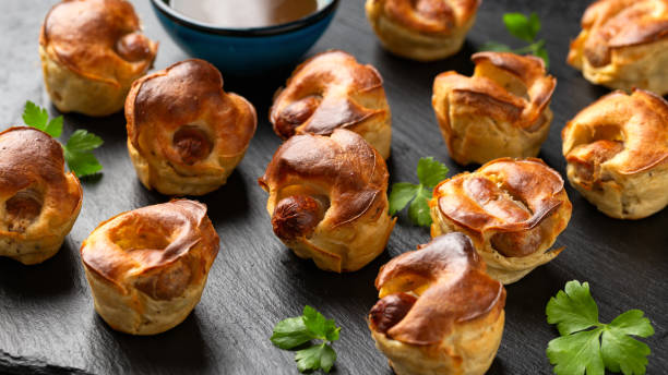 istock Mini Toad in the hole, Baked sausages in Yorkshire pudding with gravy 1845272682
