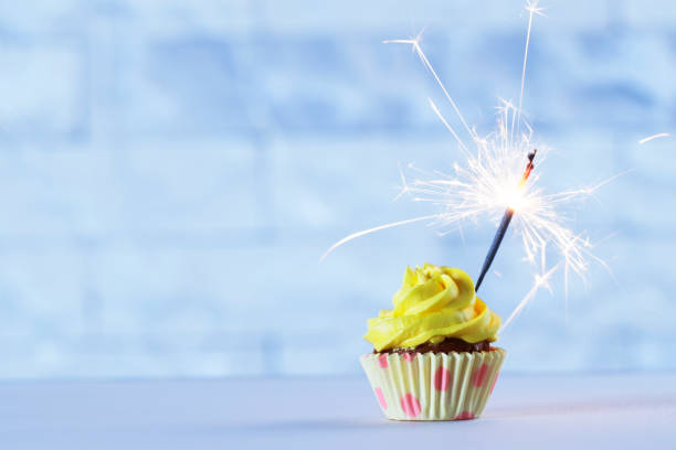 istock Delicious cupcake with sparkler on white table 1845280667