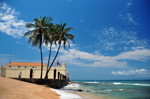 São Tomé, São Tomé and Príncipe: coconut trees, golden sand beach and the Portuguese fort of Saint Sebastian - photo by M.Torres