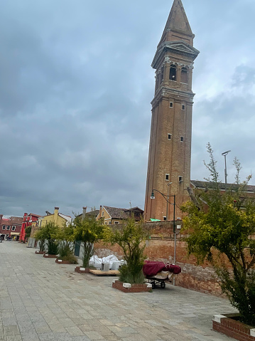 Burano, Italy - November 3 2023: The bell tower of Church of San Martino is a 16th-century, Roman Catholic church. San Martino is a 16th-century, Roman Catholic church. The bell tower has a 1.83 m inclination.