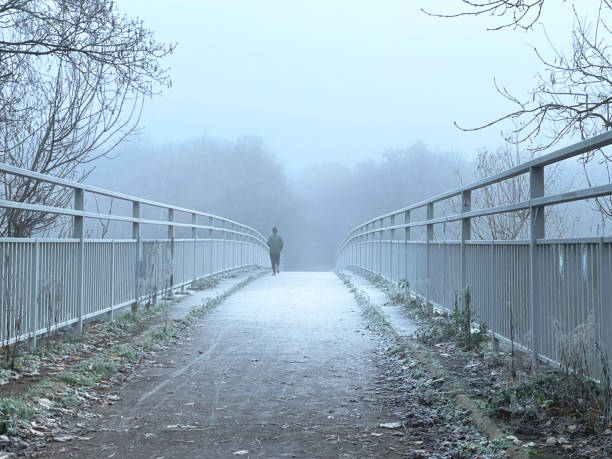 istock Jogger on a bridge in the fog 1845294928