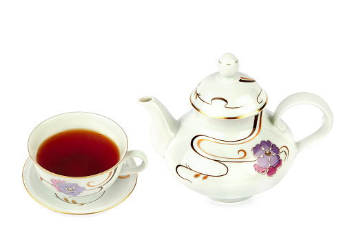 Porcelain teapot and a cup of tea isolated on a white background. Vintage china. Collage.