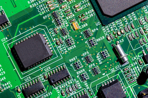 old digital circuit board with microprocessors and components, closeup full-frame macro background