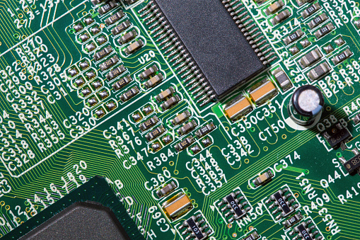 old digital circuit board with microprocessors and components, closeup full-frame macro background