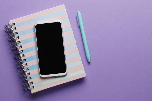 istock Phone, notebook and pen on a blue background. Place for text. Idea concept. finance concept. 1845347297