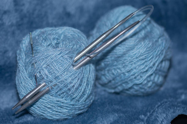 istock blue yarn and knitting needle on blue fabric. 1845369706