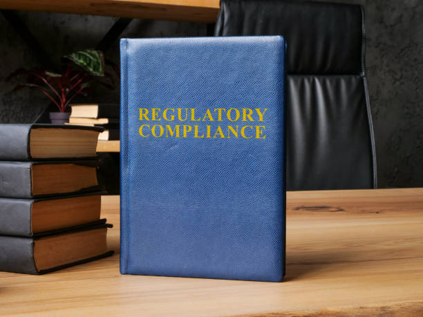 istock Regulatory compliance laws next to stack of books. 1845371833
