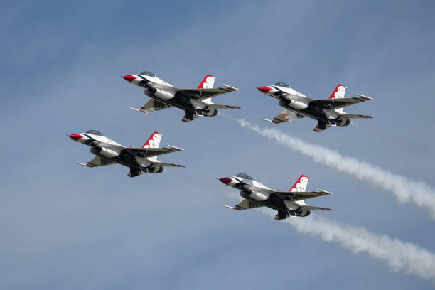 The Air Force Thunderbird aircraft team 1 thru 4 flying their F-16 Falcon aircraft in diamond formation flying to the left in level flight in blue cloudy skies. Airplane in sky performing trick. Photo Taken at the Point Mugu Airshow on 3/17/23 in Ventura County California. miramar air show stock pictures, royalty-free photos & images