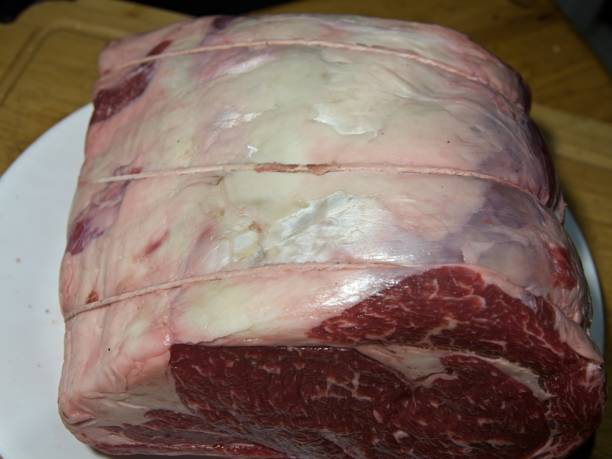 istock Beef prime rib roast in stages of preparation 1845401619