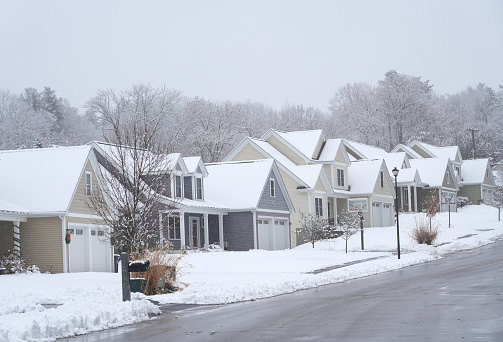 street in residential community after snow in winter