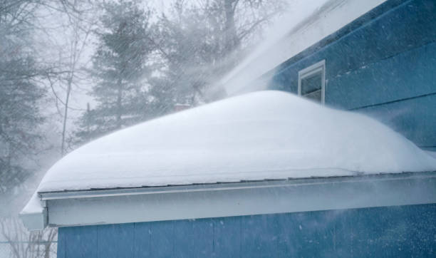 istock strong wind blowing snow off the roof in blizzard 1845457781