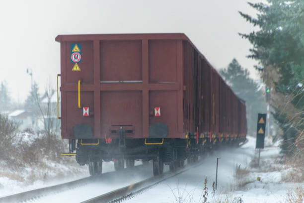 Cargo train with motor engine in winter snowy morning near cold village Lenesice CZ 12 09 2023