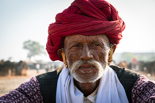 Pushkar, Rajasthan, India - November 17, 2018: Portrait of an unidentified happy old man at the Pushkar Cattle Fair, Rajasthan, India