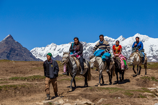 Rohtang Pass, India - Sep 17, 2014 : Indian tourists ride on horseback on the Rohtang Pass, which is on the road Manali - Leh. India, Himachal Pradesh