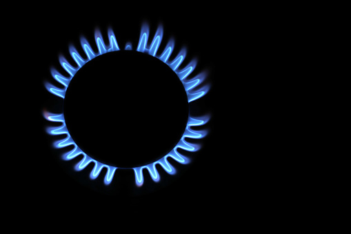 Fire on gas stove with dark background