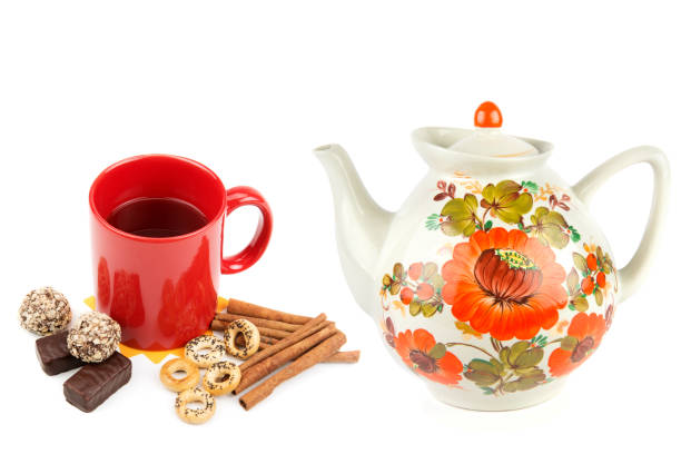 Porcelain teapot, mug with tea and sweets isolated on a white background. Collage.