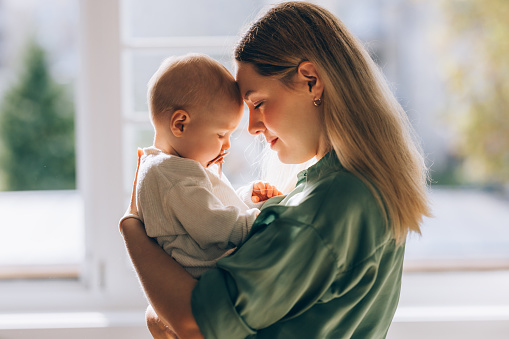 The profound connection between a loving mother and her baby, a serene snapshot of the beauty and tenderness of motherhood.