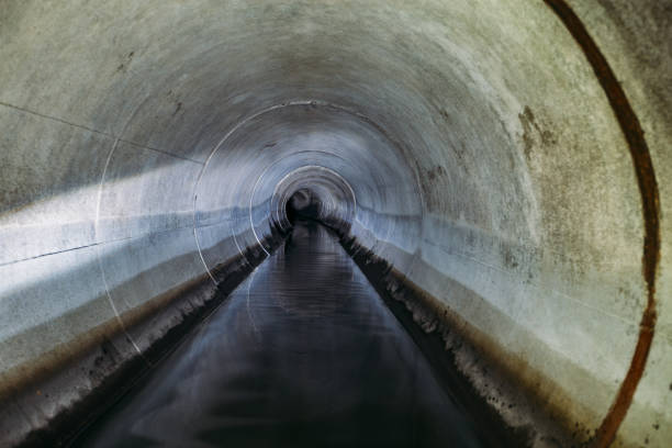 istock Industrial wastewater and urban sewage flowing through round sewer pipe 1845501710