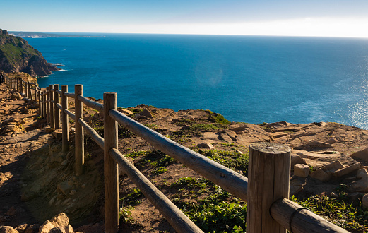 Wooden fence of Cabo de Roca or Roca cape, most western point of Europe, where the mainland ends and the Atlantic begins, landscape, Portugal