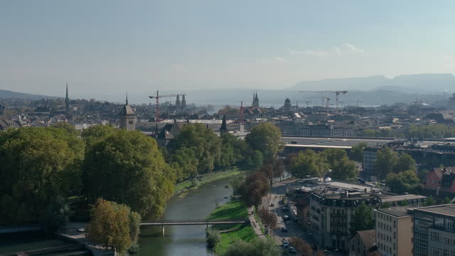 sunny day zurich city center riverside construction cranes aerial panorama 4k switzerland