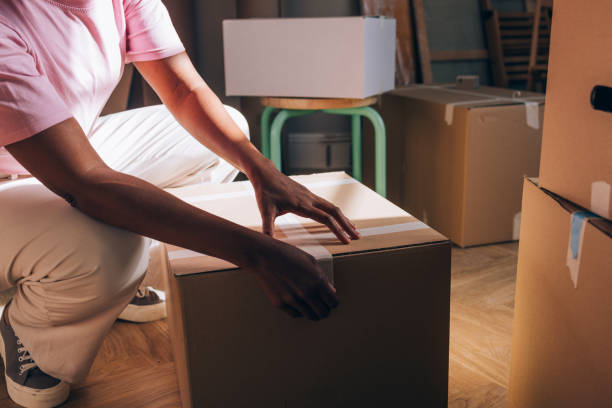 istock New Beginnings: Woman Unpacking Boxes in Fresh Apartment 1845515229