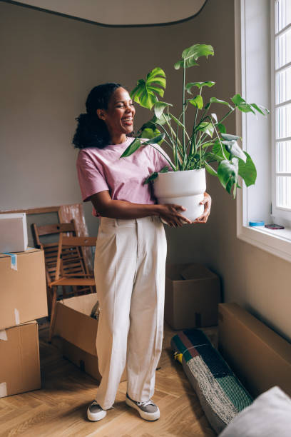 istock New Beginnings: Woman Unpacking Boxes in Fresh Apartment 1845515247