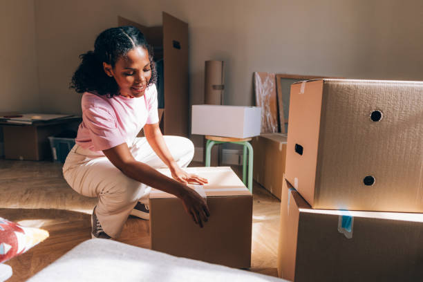 istock New Beginnings: Woman Unpacking Boxes in Fresh Apartment 1845515266