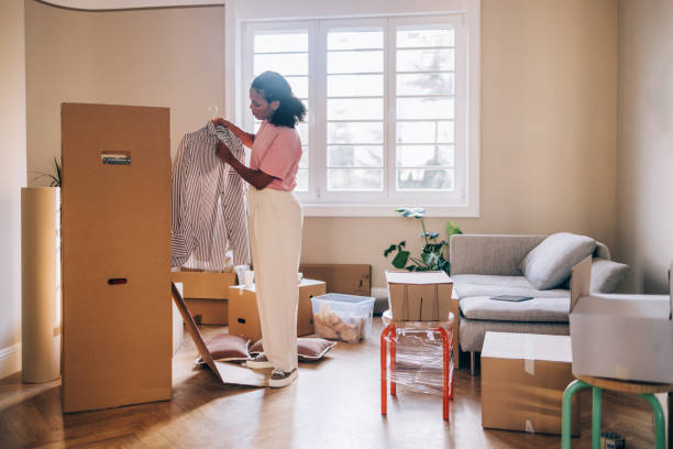istock New Beginnings: Woman Unpacking Boxes in Fresh Apartment 1845515816
