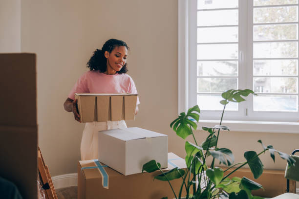 istock New Beginnings: Woman Unpacking Boxes in Fresh Apartment 1845515827