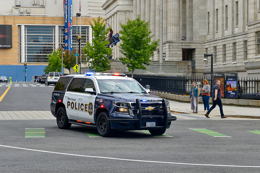 Santa Ana, California, USA - November 6, 2021:  A Santa Ana Police cruiser idles on a street corner.