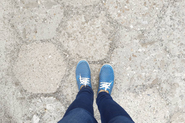 istock Feet in moccasins stand on sidewalk. View from above. 1845560849