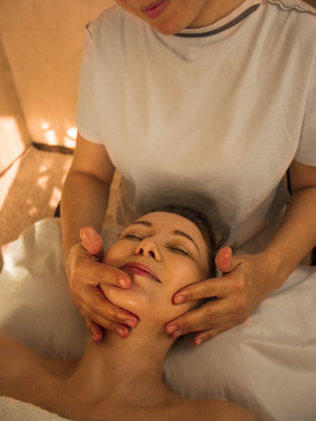 istock masseur doing facial massage, Facebuilding Massage. 1845603471