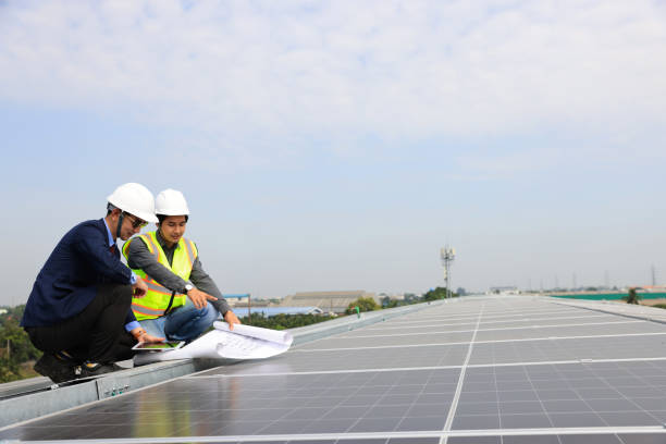 istock Engineer and businessman working onsite at solar roof, Progressive with solar project 1845612913