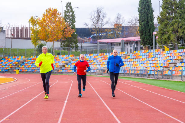 istock Mature men running in an athletics track 1845613432
