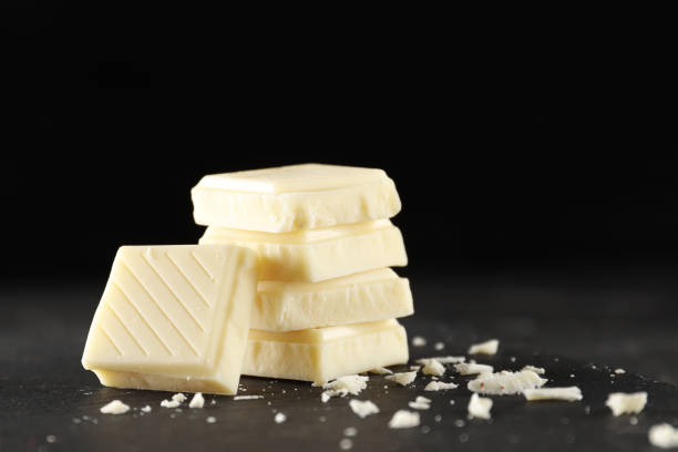 istock Pieces of White Chocolate on a dark background. Place for text. 1845636817